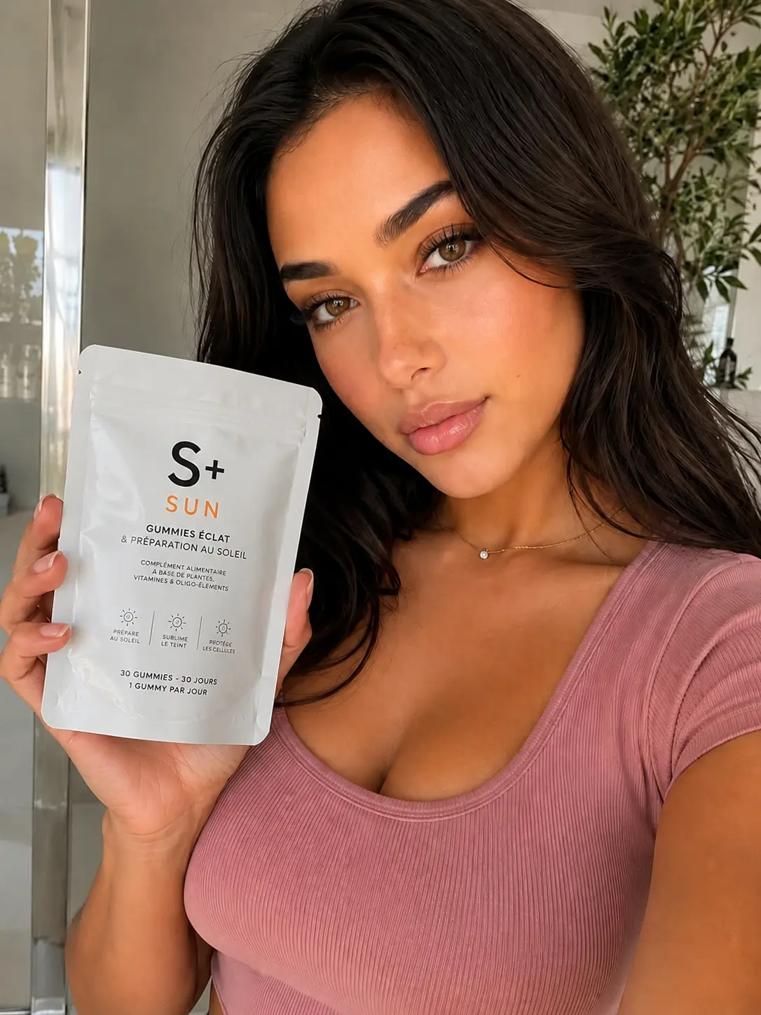 S+ customer holding the S+ SUN pouch