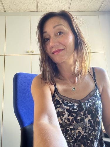 Smiling customer showing her tanned arm