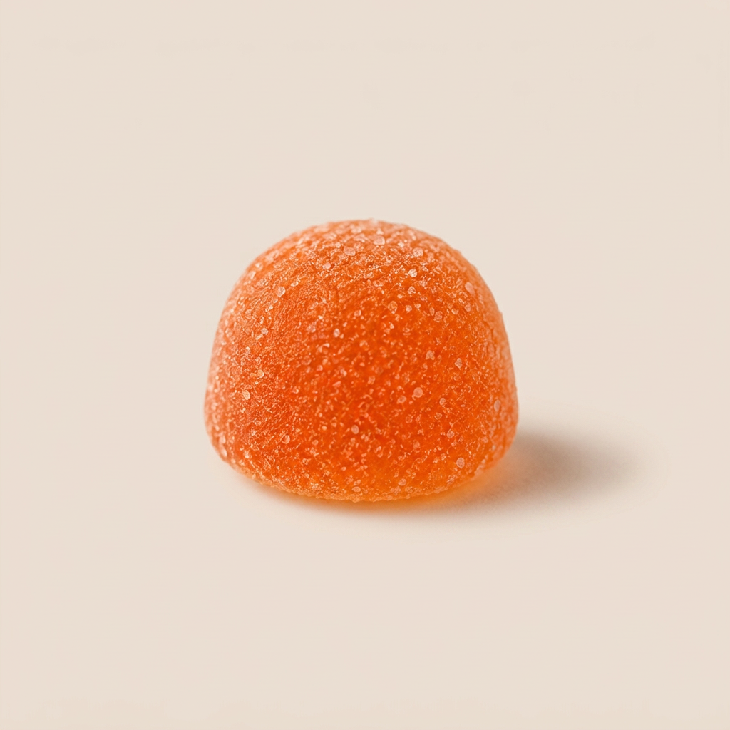 Close-up of an S+ SUN self-tanning gummy