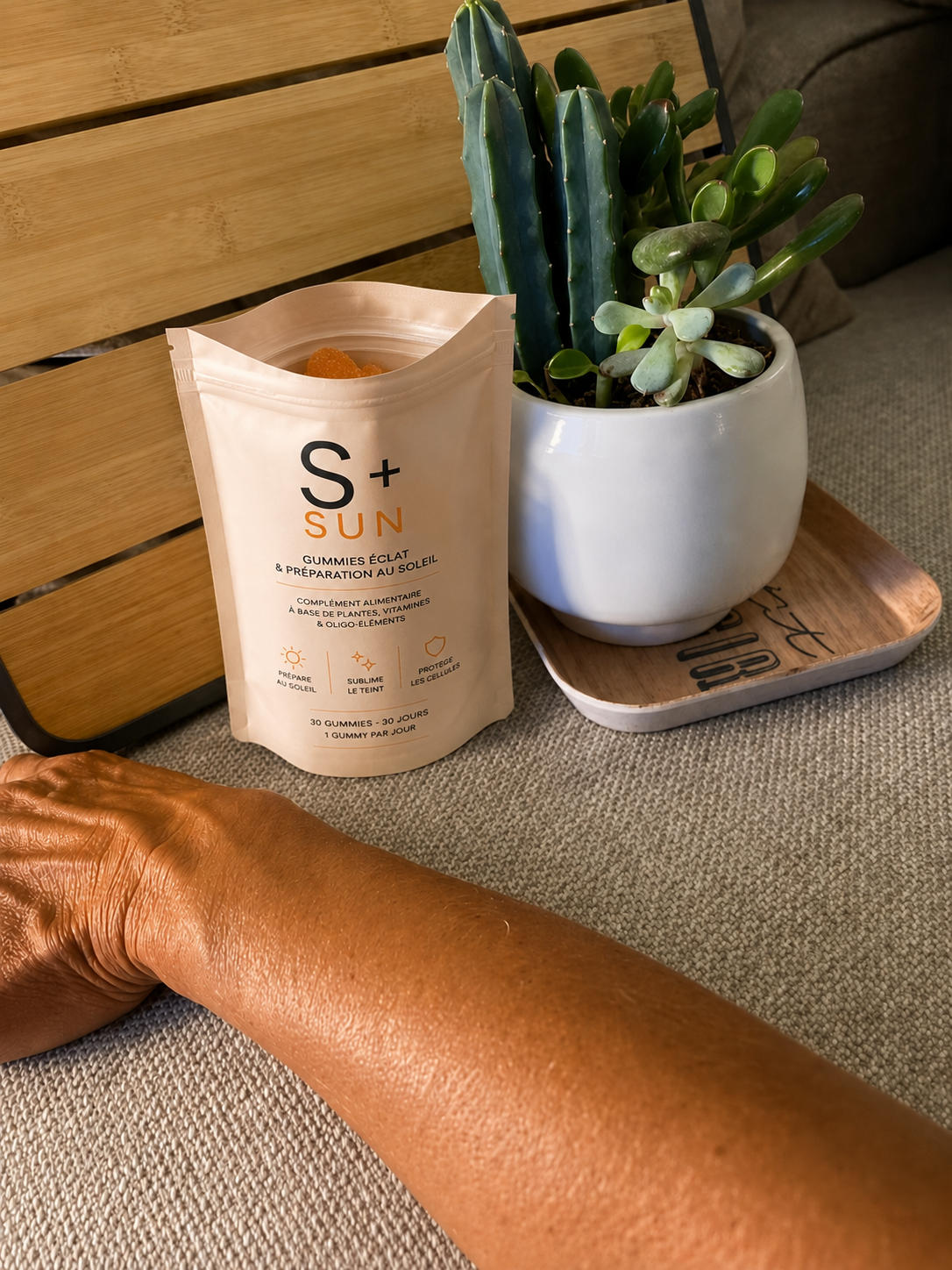 S+ SUN pouch next to a tanned arm