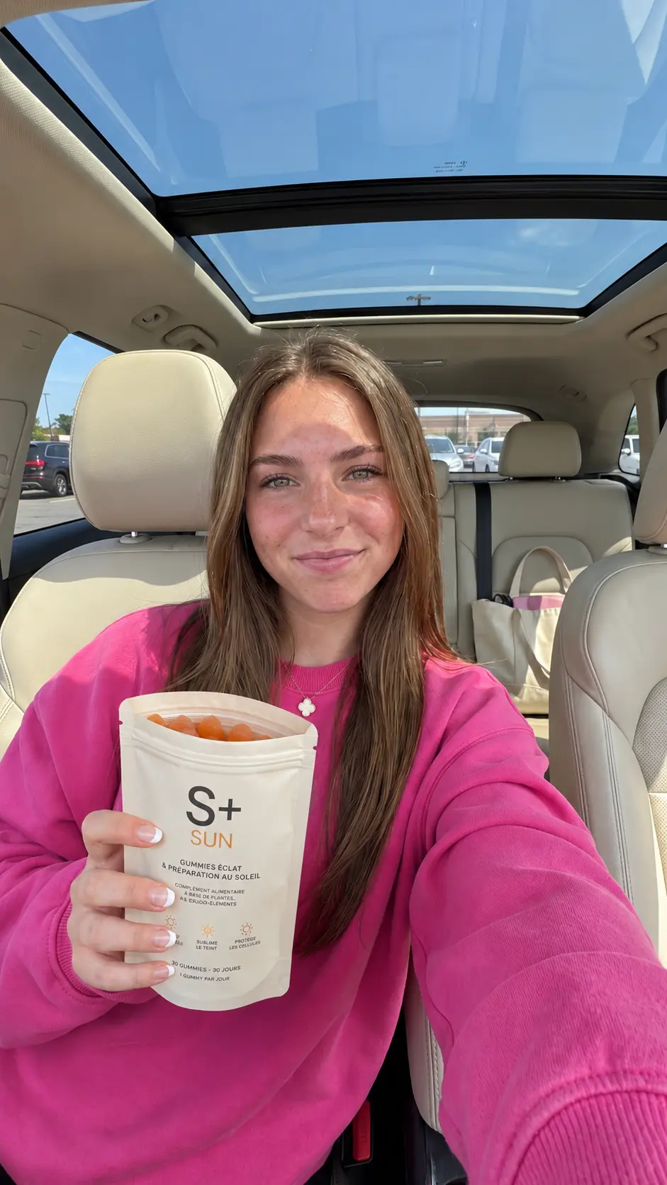 S+ customer in her car with the S+ SUN pouch